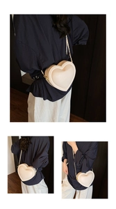 Detail of cream white heart-shaped crossbody bag with elegant gold chain strap for women
