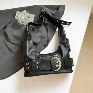 Detail of black matte moto bag featuring half-moon metal buckle and eyelet strap