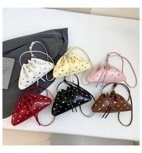 Collection of mini drawstring bucket bags with silver studs in six vibrant fashion colors