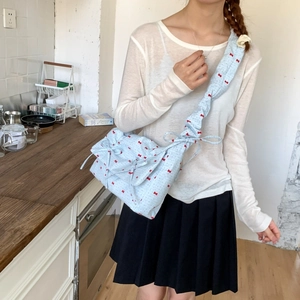 Floral shoulder bag with red bows, light blue fabric, and stylish ruched drawstring straps