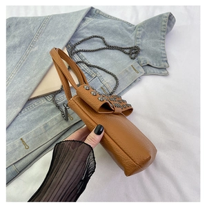 Brown faux leather mini crossbody bag with large bow and silver rivet chain detail