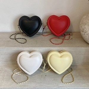 Chic heart-shaped crossbody bags in black, red, white, and beige with metal chain straps