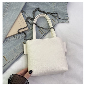 Close-up of white lychee textured PU leather mini bag with dark grey metal chain strap