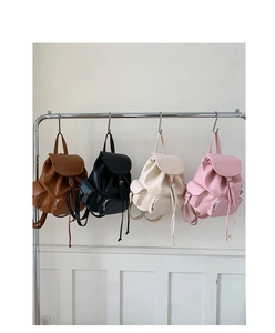 Selection of soft leather backpacks in brown black beige and pink with drawstring closure