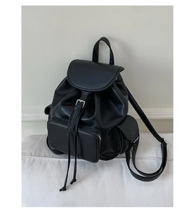 Detail view of the black retro PU leather backpack with magnetic flap and front pocket