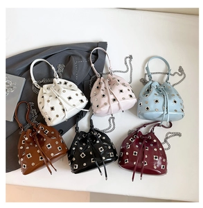 Detail view of multicolored bucket bags featuring star rivets and chain straps in 6 colors