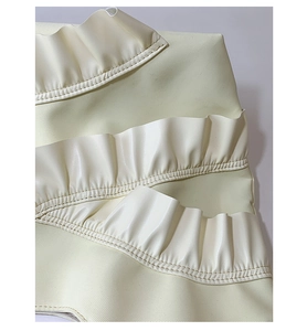 Detailed view of layered cream ruffled nylon fabric with premium stitching on a tote bag