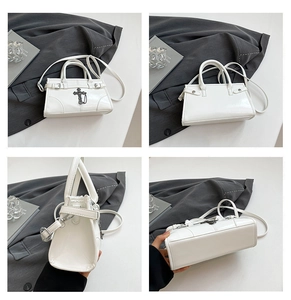 Detailed four-way view of white glossy leather Boston bag with gothic metal cross accents