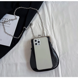 Detail view of a vintage black leather kiss-lock phone bag with silver chain strap