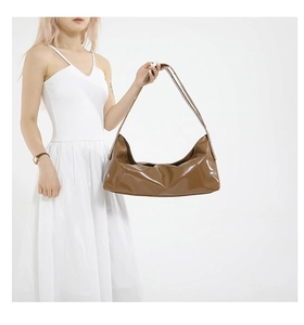 Caramel brown crescent shoulder bag with high-gloss finish and spacious interior design