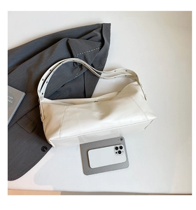 Detail of adjustable strap and spacious interior of the cream crescent shoulder bag