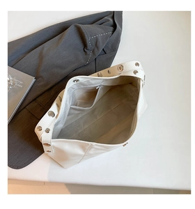Detail of white Hobo shoulder bag showing spacious interior lining and rivet strap