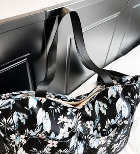 Close-up of tropical floral print tote bag featuring sturdy wide nylon handles and zipper