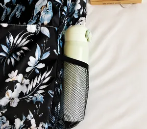 Close-up of durable mesh side pocket on floral backpack with water bottle storage