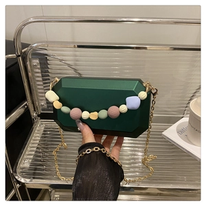 Macro view of geometric octagon evening bag with pastel resin beads and gold chain strap