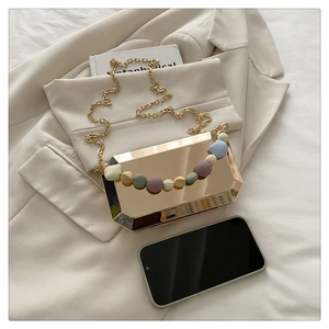 Detailed size comparison of gold octagonal box clutch with colorful matte beads