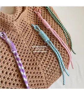 Detailed close-up of soft knitted multicolored rope charms with striped woven patterns