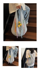 Detail of light blue crochet tote bag with colorful tassels on wooden stairs