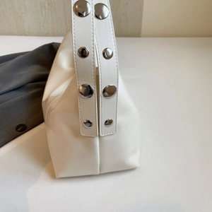 Vintage white crescent shoulder bag with silver rivet straps and geometric side design