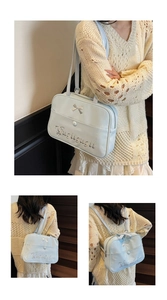 Detail showing the light blue glossy tote bag with silver bow and adjustable straps