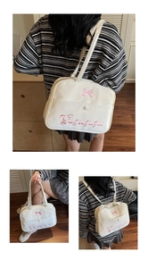 Close-up of white JK style tote bag with pink bow embroidery and versatile straps
