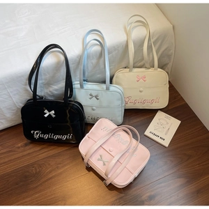 Close-up of four colors of JK uniform tote bags with bow details and embroidery