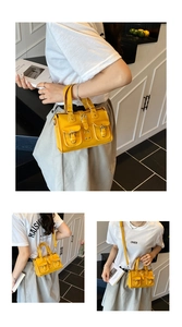 Detail of yellow pebbled leather handbag featuring double front flap pockets and straps