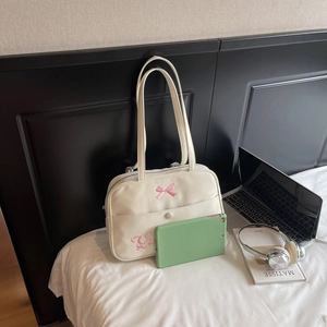 White minimalist tote bag with pink bow and long shoulder straps for college students