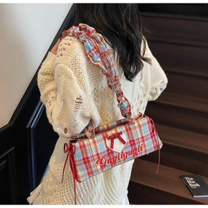 Detail of red and blue plaid canvas tote bag with heart patch and bow detail