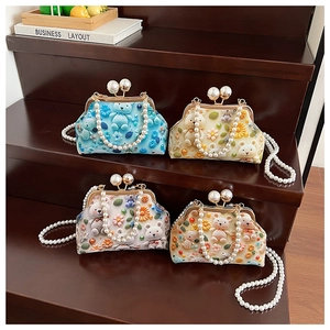 Detail of colorful knit crochet shell bags with pearl chains and 3D plush bear charms