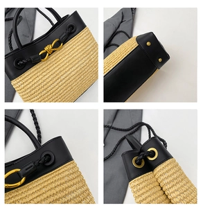 Close-up of woven straw handbag with black leather trim and gold chain metal hardware