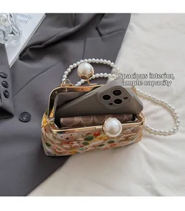 Macro shot of embroidered bear bag interior holding a smartphone and wallet