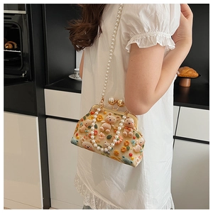 Detail of crochet crossbody bag with 3D bear ornaments and white pearl shoulder strap