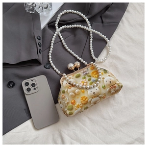 Close-up of cute floral shell bag with beaded strap, 3D bear pattern and pearl clasp