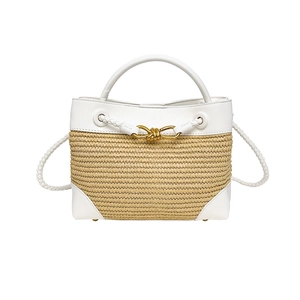 Summer straw woven tote bag with white leather trim and a gold bow knot buckle
