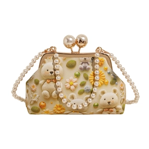 Elegant beaded shell bag with bear and daisy prints featuring a large pearl clasp and handle