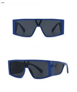 Close-up of royal blue flat top shield sunglasses featuring metal V logo on bridge