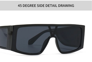 Detail view of large frame sunglasses with black frame and gold V-shaped metal logo