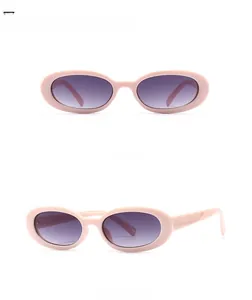 Pink oval frame sunglasses with gradient grey lenses shown from front and side views