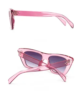 Side and back view of retro cat-eye sunglasses with pink frames and purple gradient lenses