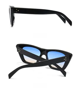 Detail view of vintage cat-eye sunglasses with flat top and gold rivet accents