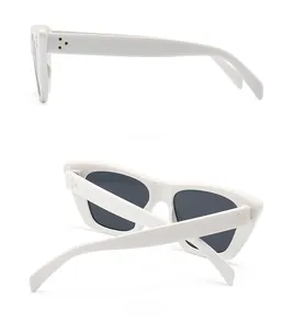 Detail view of white flat top sunglasses with three-dot metal rivets and thick temples