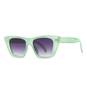 Modern cat eye sunglasses with light green frame, purple gradient lenses and gold studs