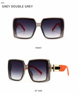 Detailsicht der quadratischen Rock-Sonnenbrille mit grauen Gläsern und orangen Bügeln