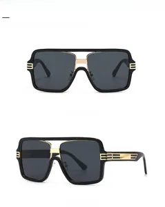 Detailed views of black oversized square sunglasses with gold temple accents and grey lenses