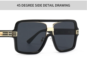 Close-up of black oversized square sunglasses featuring elegant gold metal bridge and temples