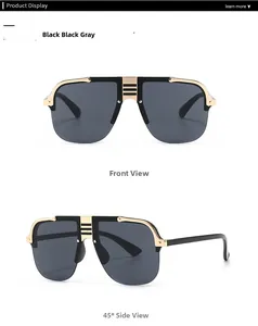 Detail view of oversized black and gold sunglasses with square frames and metal edges