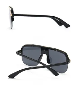 Flat top oversized sunglasses with grey lenses and gold metal details in two views