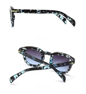 Detail view of tortoiseshell frame sunglasses with gradient lenses and gold hinge
