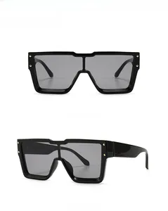Front and side views of oversized black frame sunglasses with dark grey lenses and gold rivets